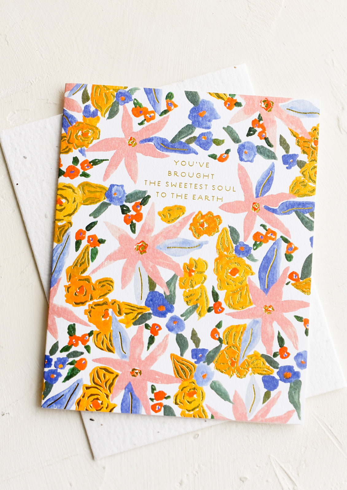 A floral printed card with text reading "You've brought the sweetest soul to the earth".