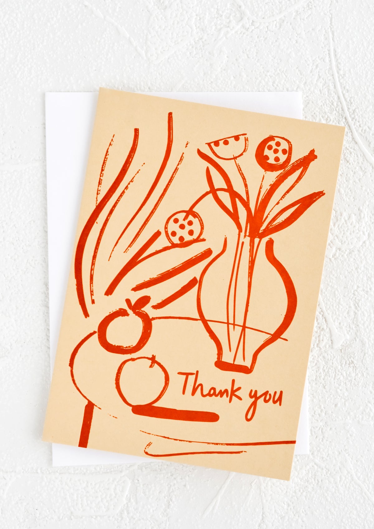 Beige greeting card with red letterpress printed still life scene and "thank you" text.