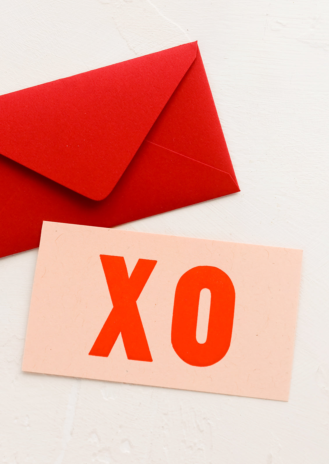 A small card with "XO" in big letters, with mini red envelope.