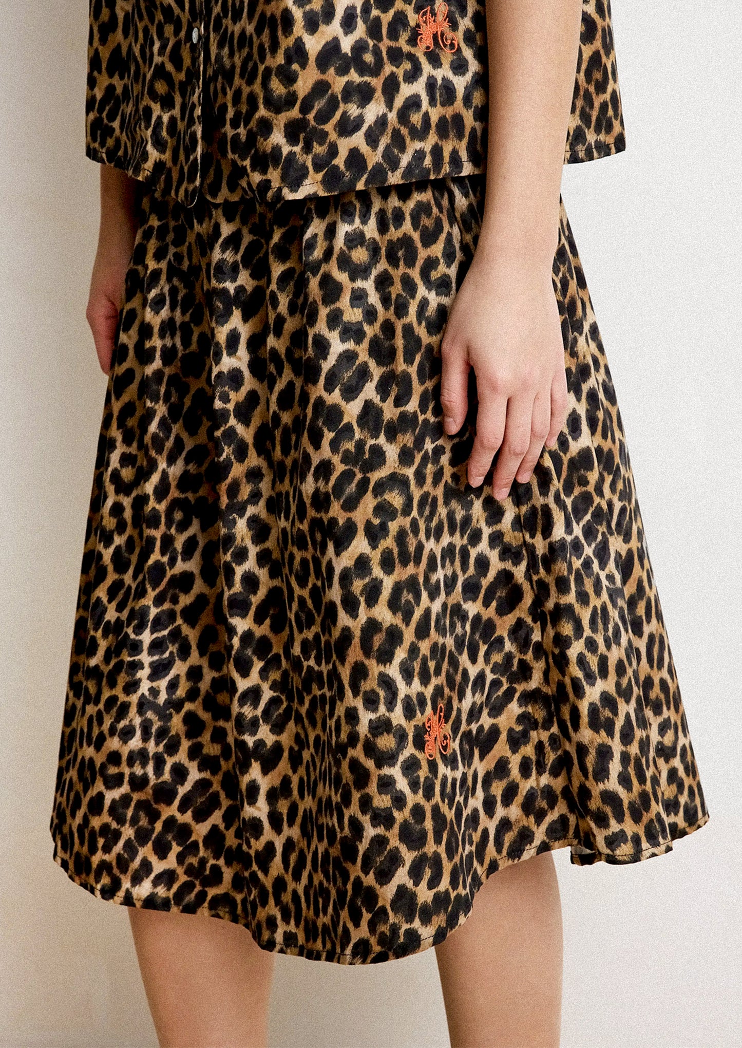 Leopard print skirt worn by a person on a plain background