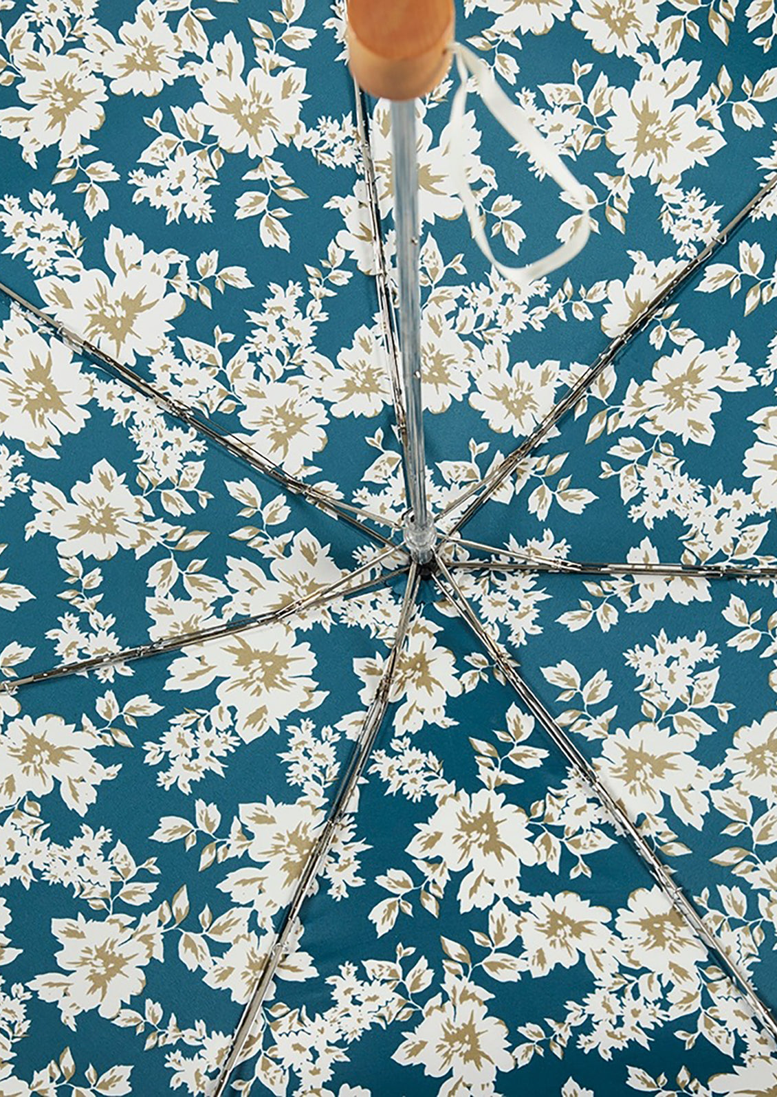 A floral print umbrella with metal spokes.