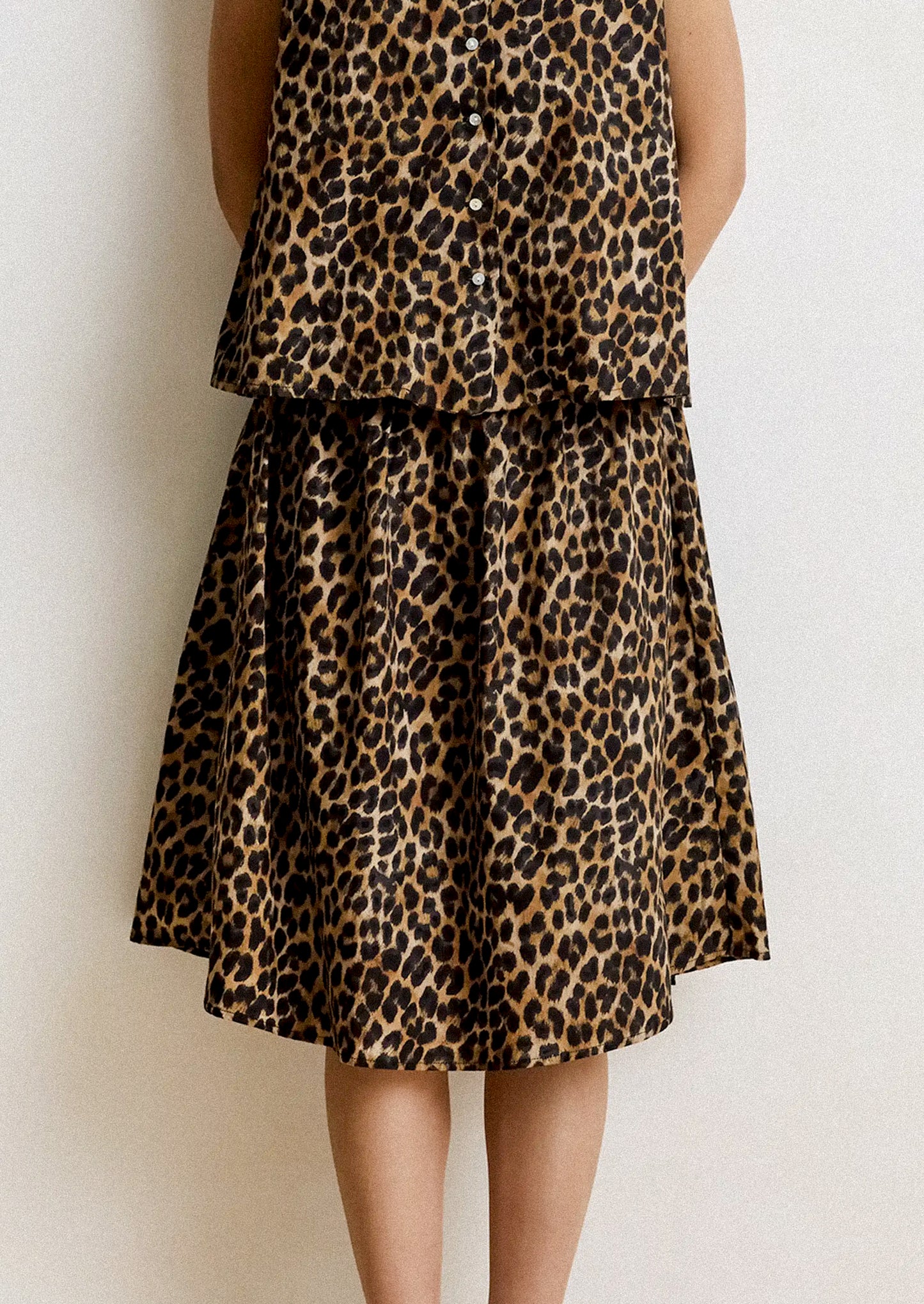 Leopard print skirt worn by a person on a plain background