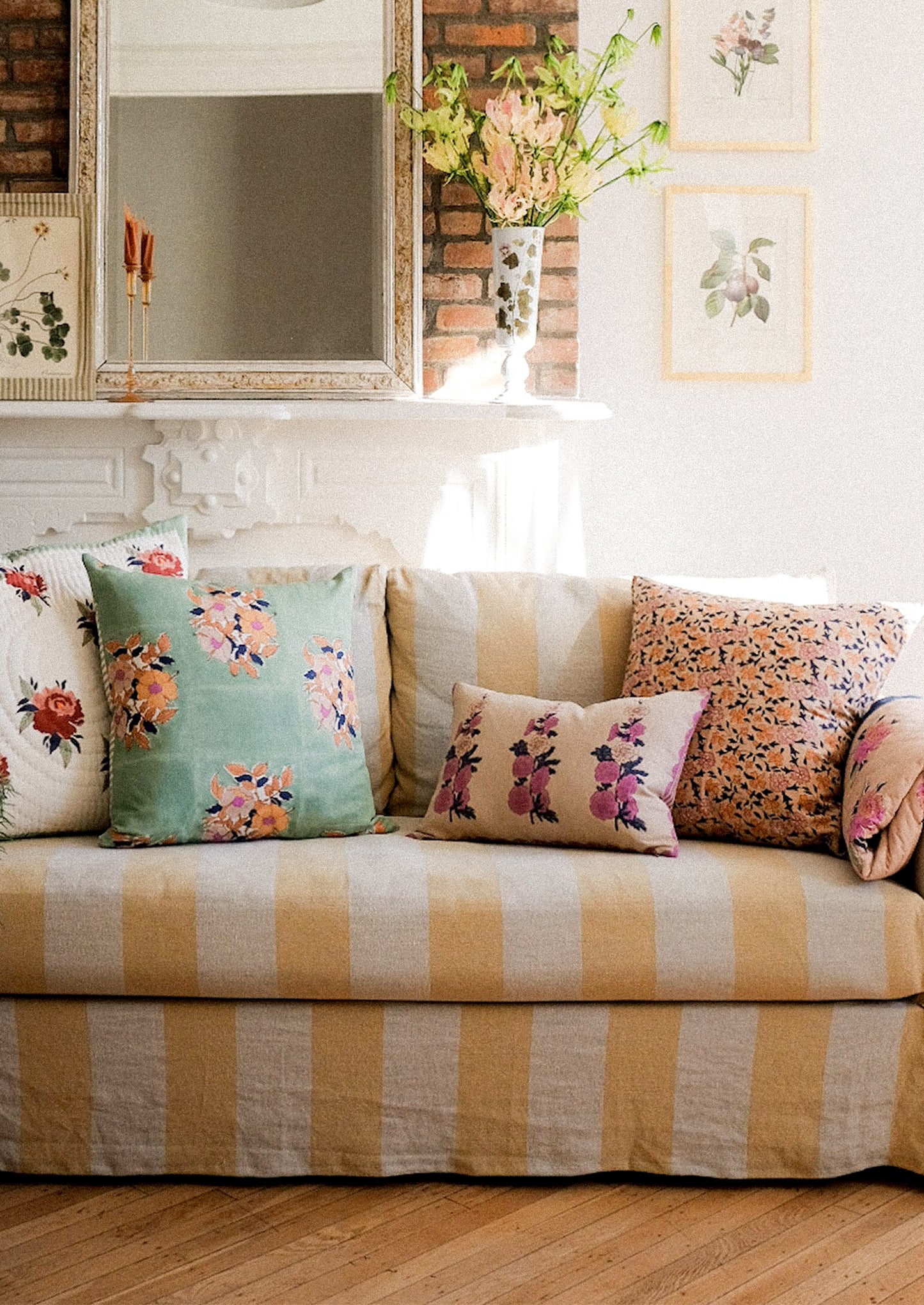 Assorted throw pillows on a slipcover sofa.