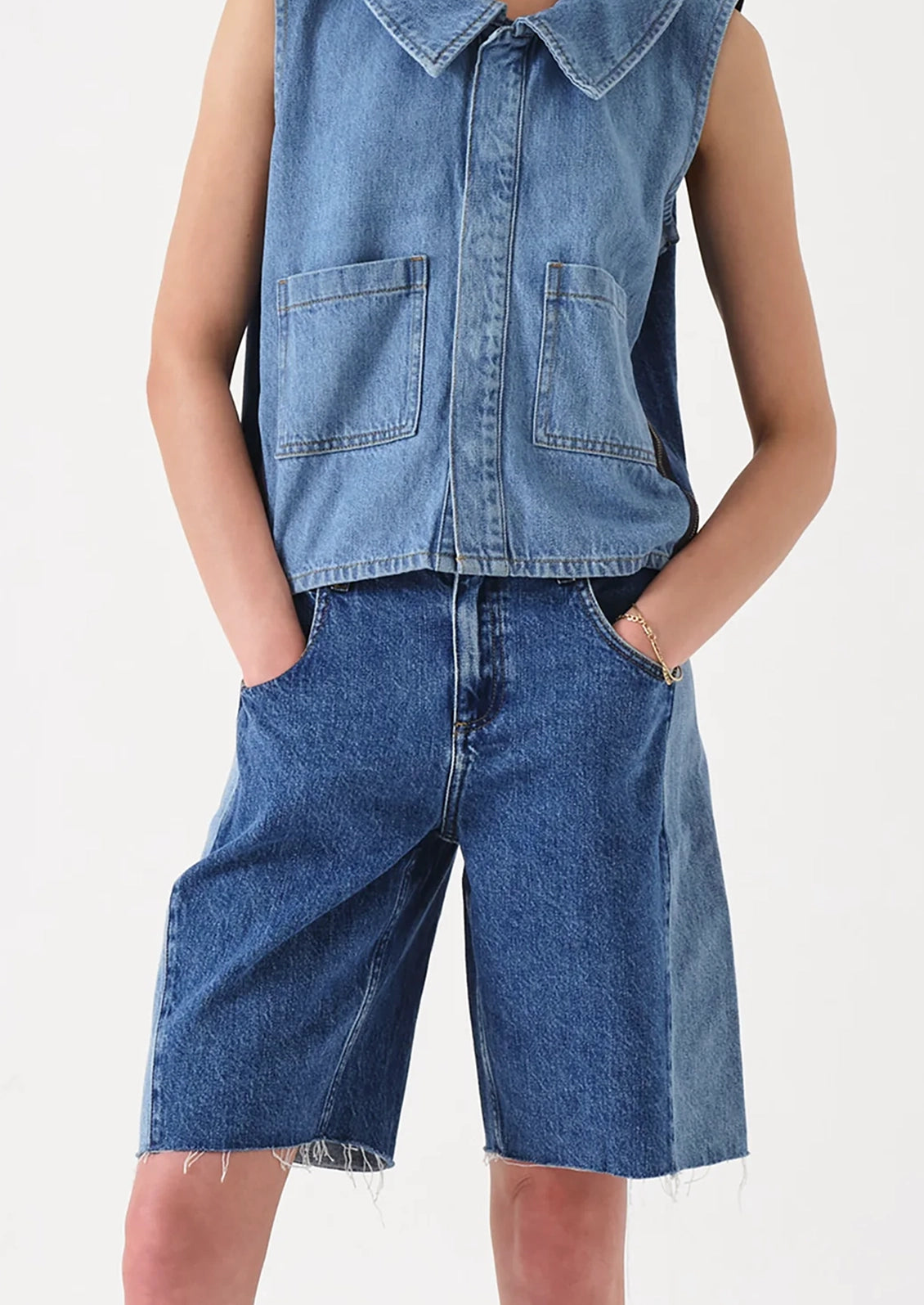 A person wearing a pair of shorts with two-tone side seam.