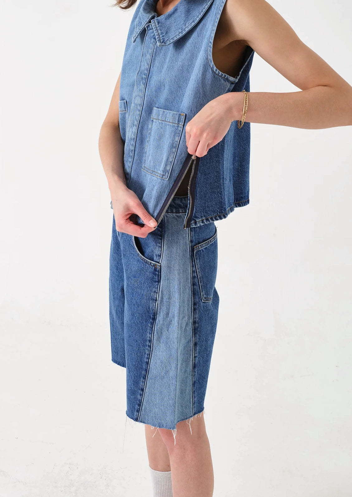 A person wearing a pair of shorts with two-tone side seam.