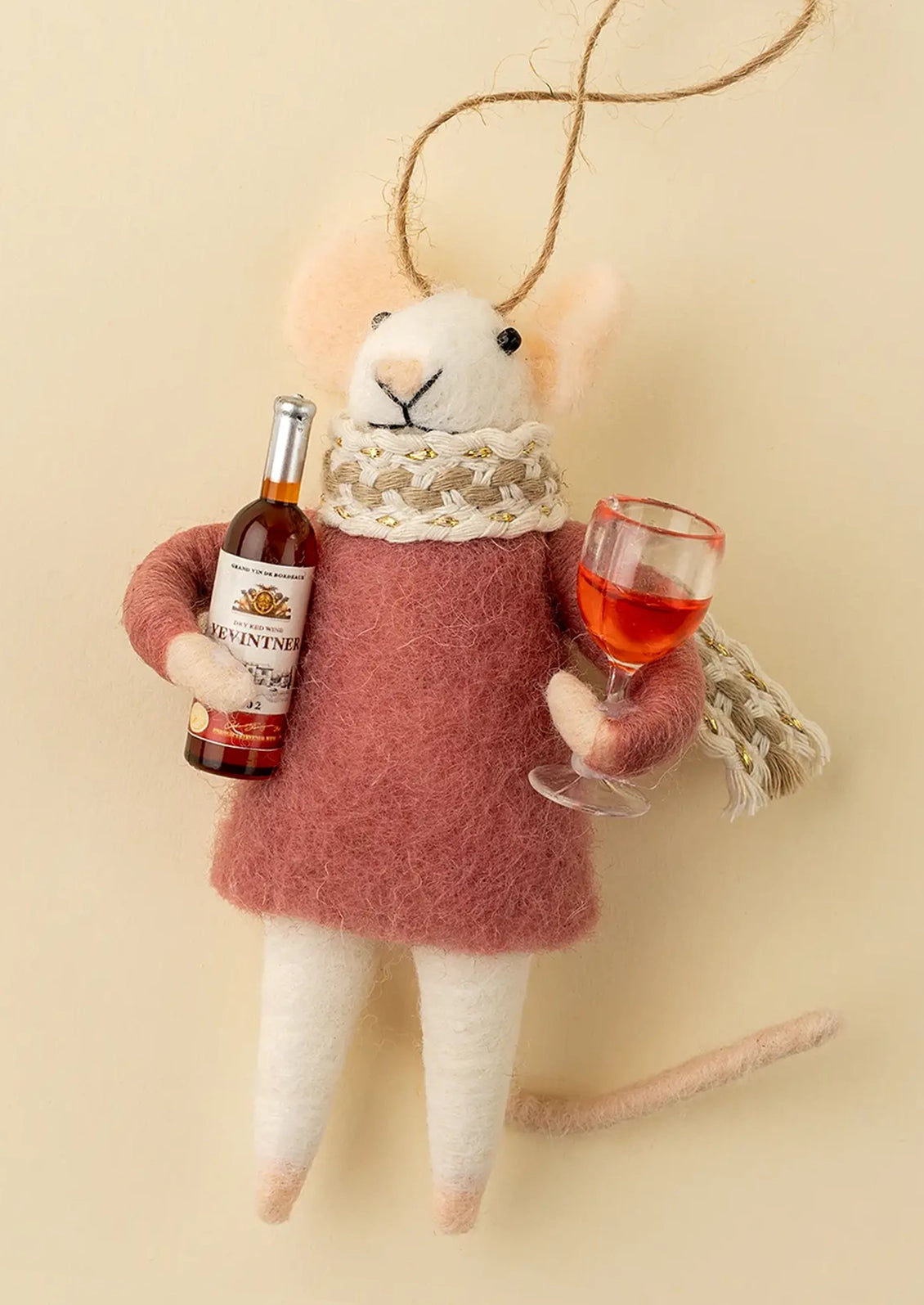A felted wool mouse ornament holding a bottle of wine and wine glass.