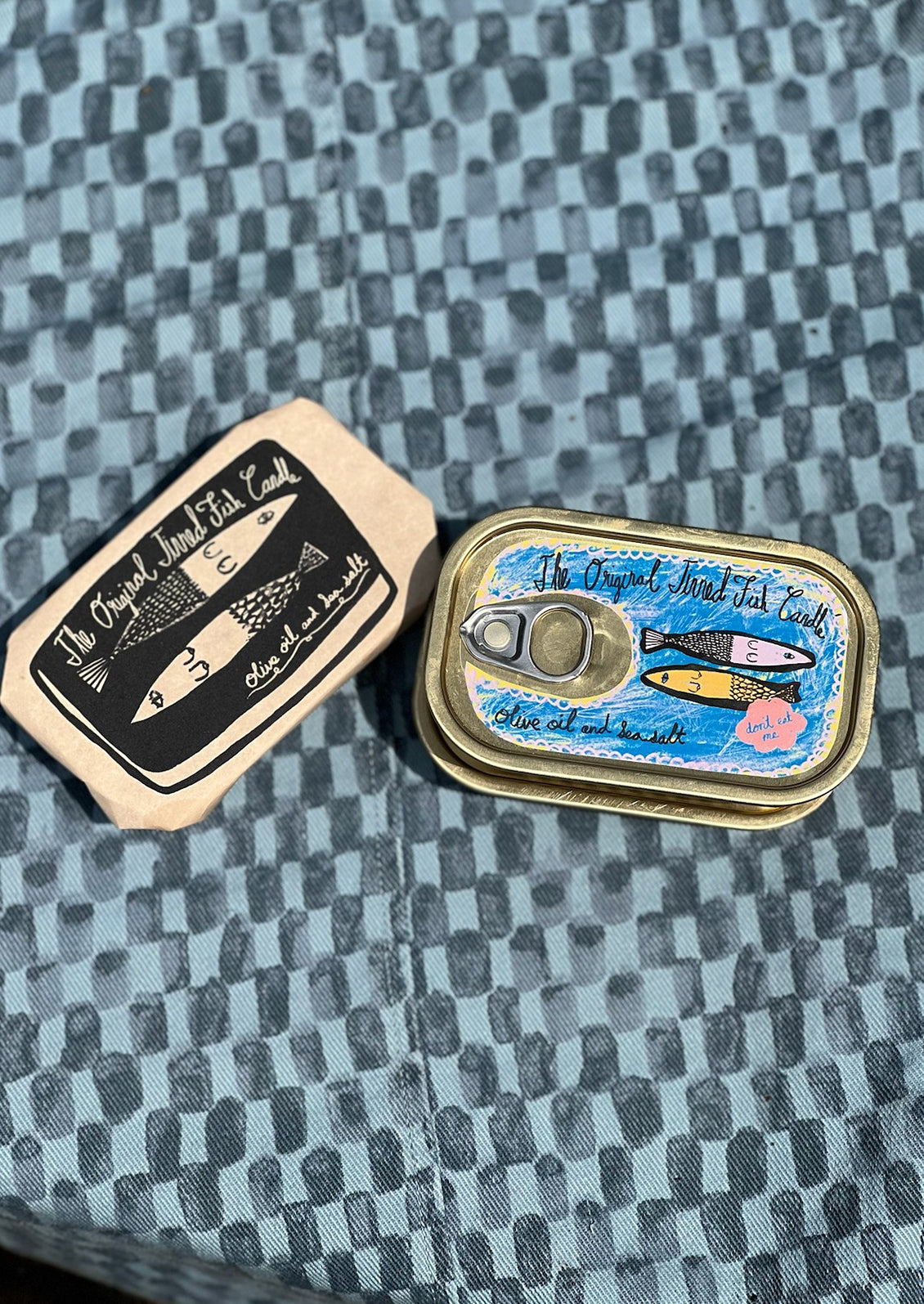 Multicolor tin of sardine candles.