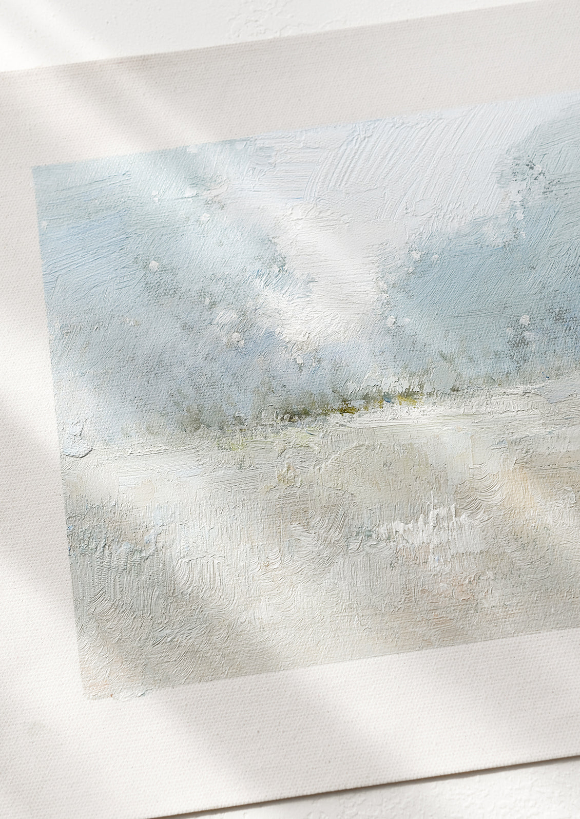 An original oil painting on unstretched canvas of pale colored landscape.