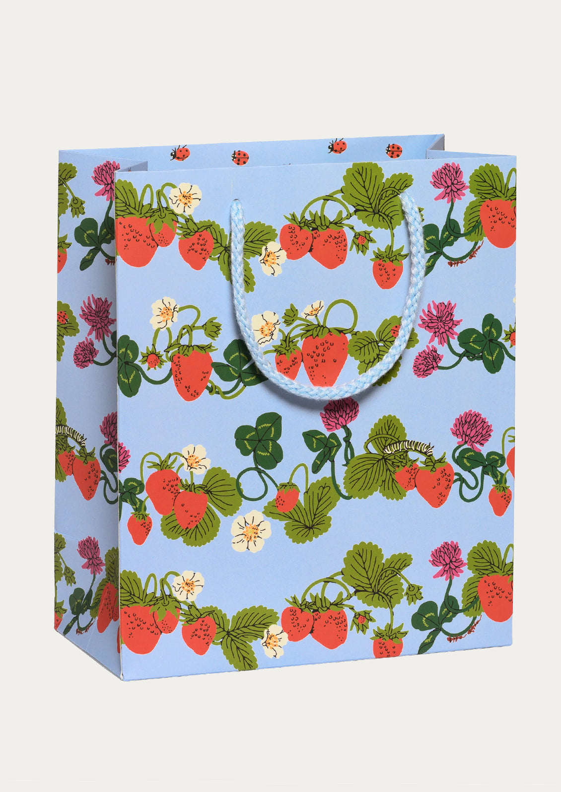 A light blue gift bag with a pattern of red strawberries, green leaves, and small white flowers.