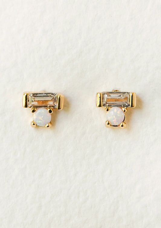A pair of gold earrings with a baguette shaped gem stacked on top of an opal gem.
