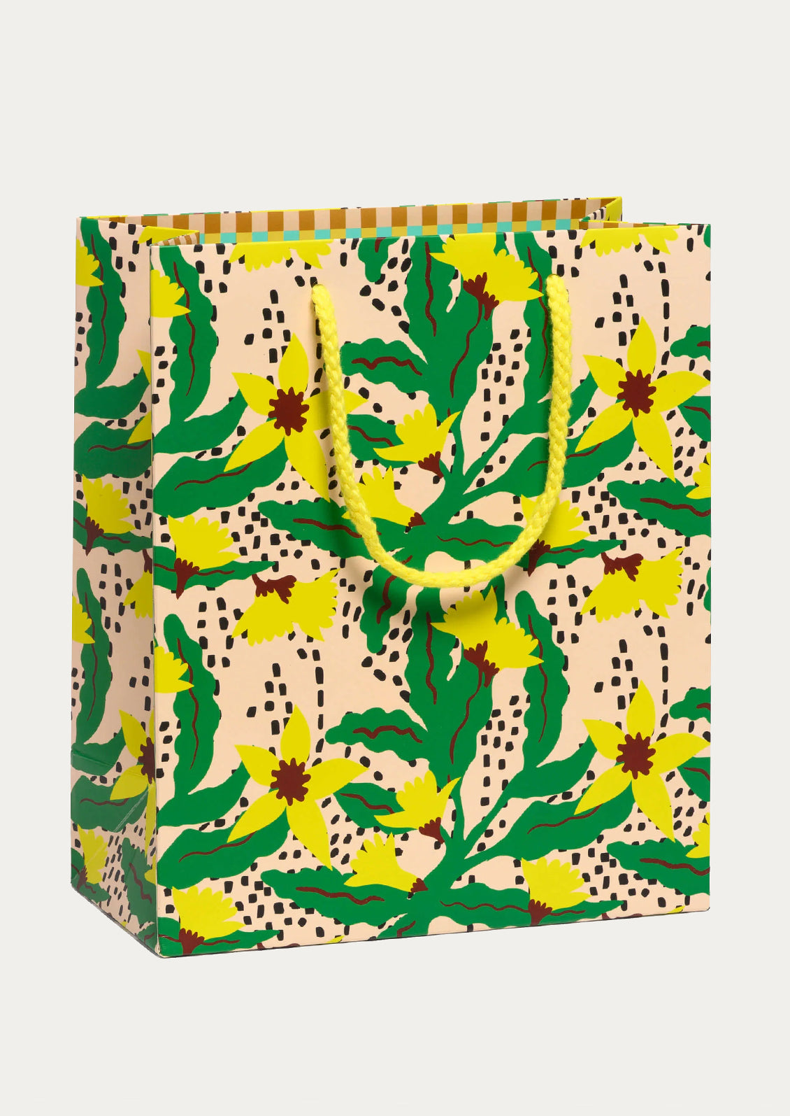 A decorative gift bag with a colorful botanical pattern featuring green leaves, yellow flowers, and black dotted accents on a beige background.