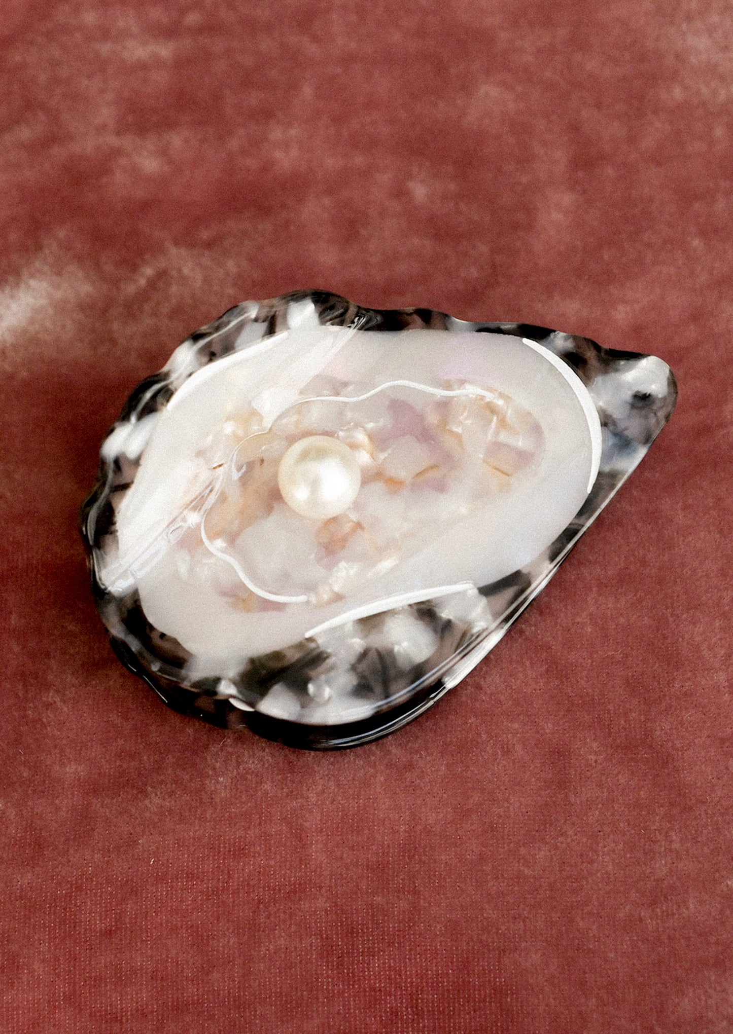 A hair claw in the shape of an oyster.