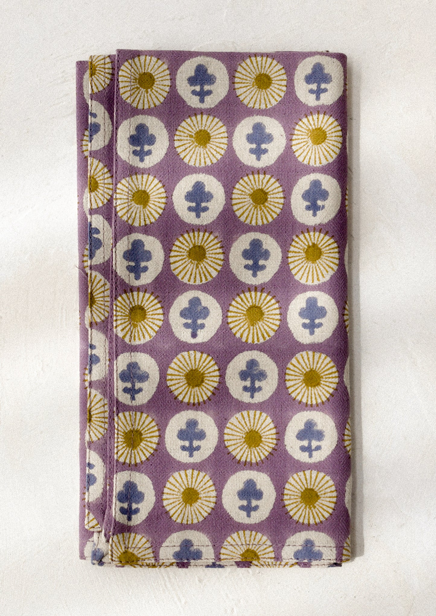 Purple dinner napkin with floral pattern on a white background
