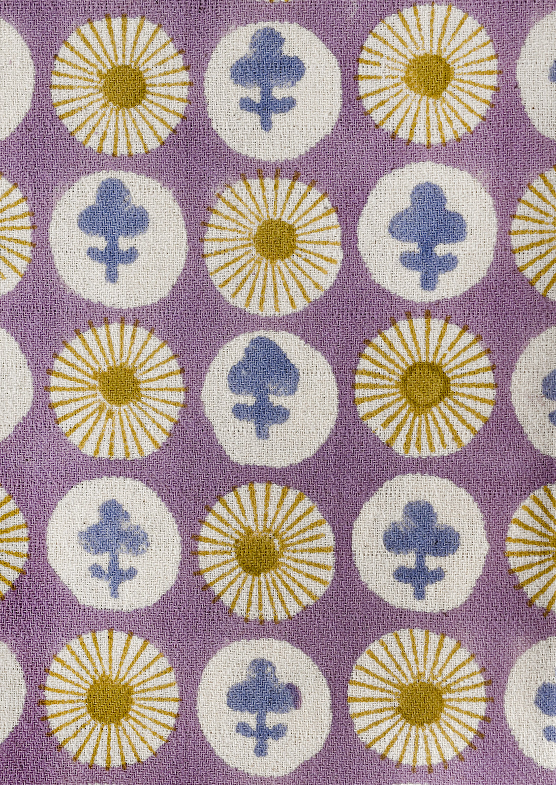 Patterned fabric with floral and circular designs on a purple background