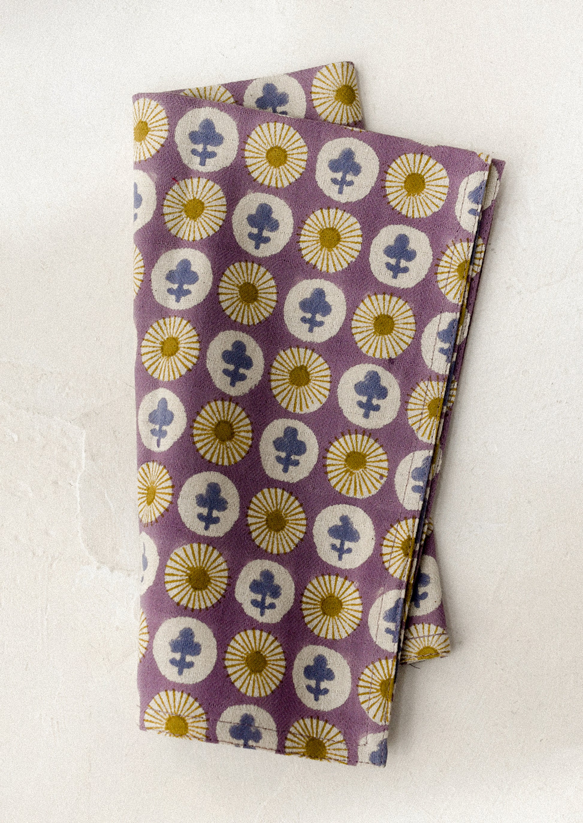 Purple dinner napkin with floral pattern on a white background