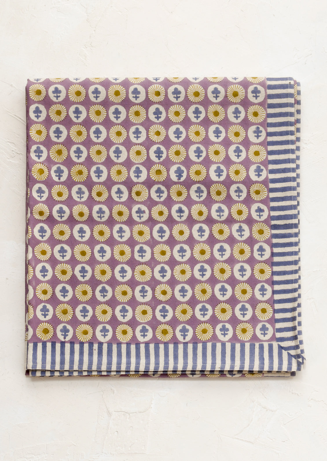Patterned fabric with floral and striped design on a white background