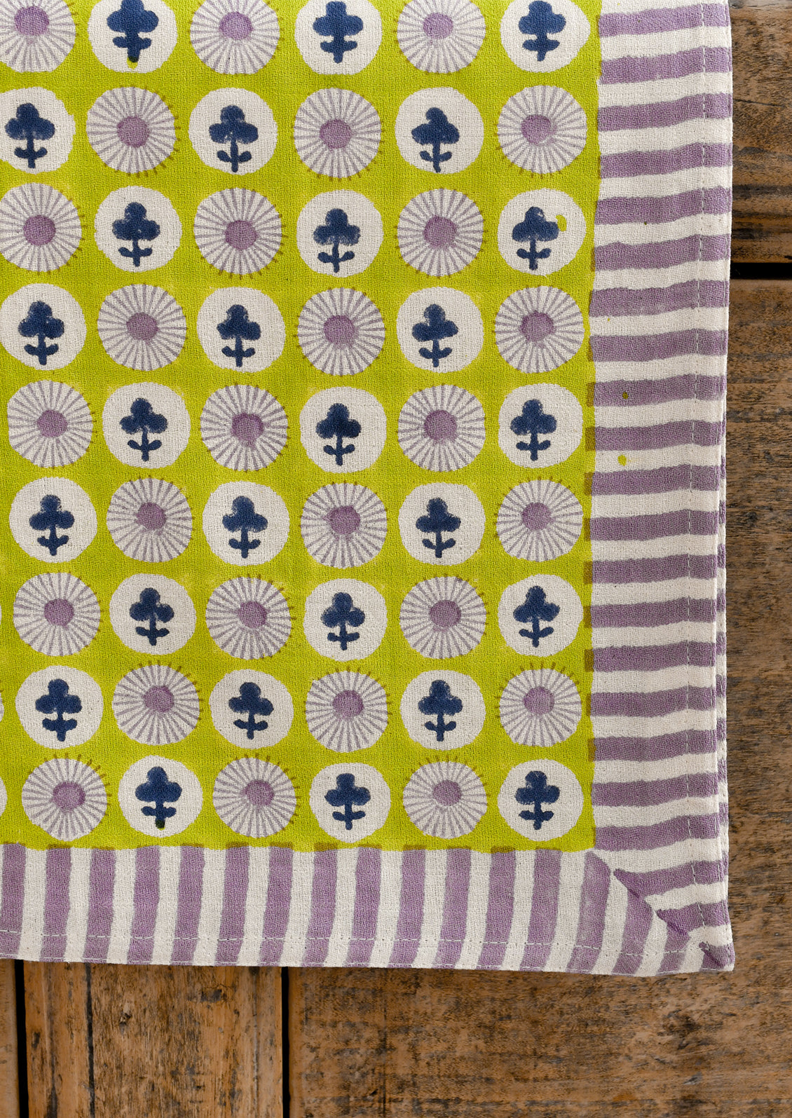 Fabric with floral and striped pattern on a wooden surface