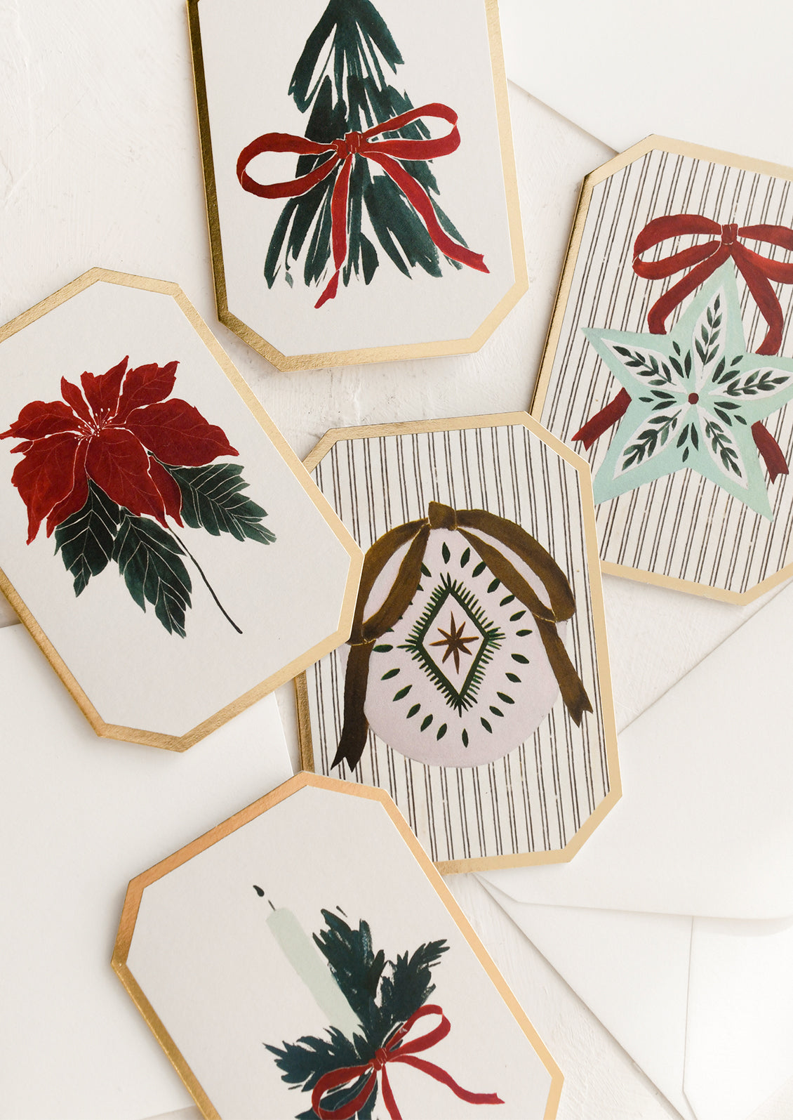 An assortment of holiday themed mini diecut greeting cards.