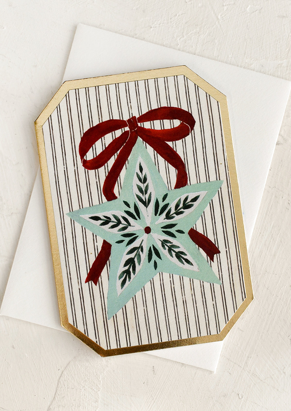 A mini die cut greeting card with ornament illustration.