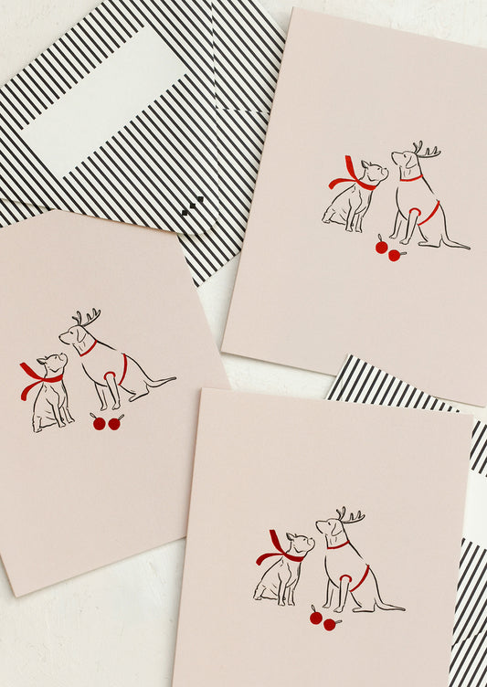 Pink greeting cards with illustration of two dogs wearing red scarves.
