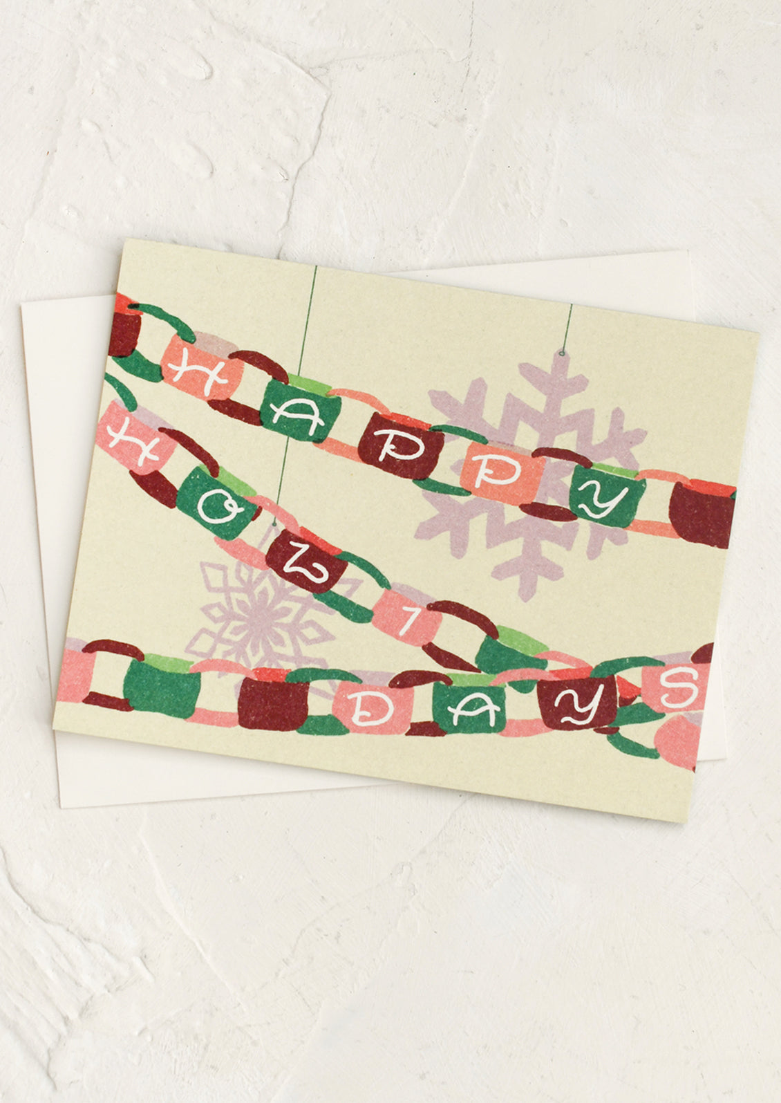 A greeting card with depiction of paper chain garland, text reads "Happy Holidays".