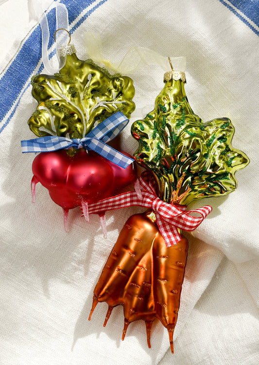 Glass ornaments depicting bundles of carrots and radishes, tied with gingham ribbon.