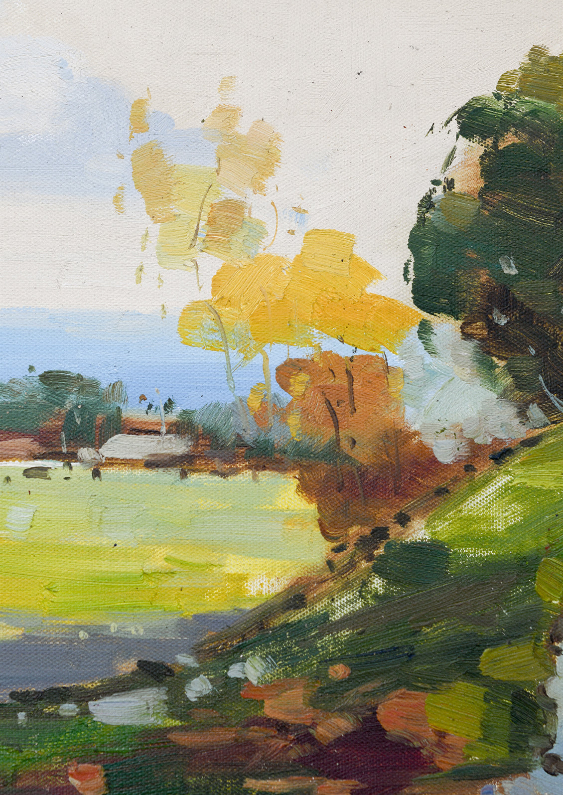 A framed landscape painting in bright yellow, green and blue tones depicting a hillside.