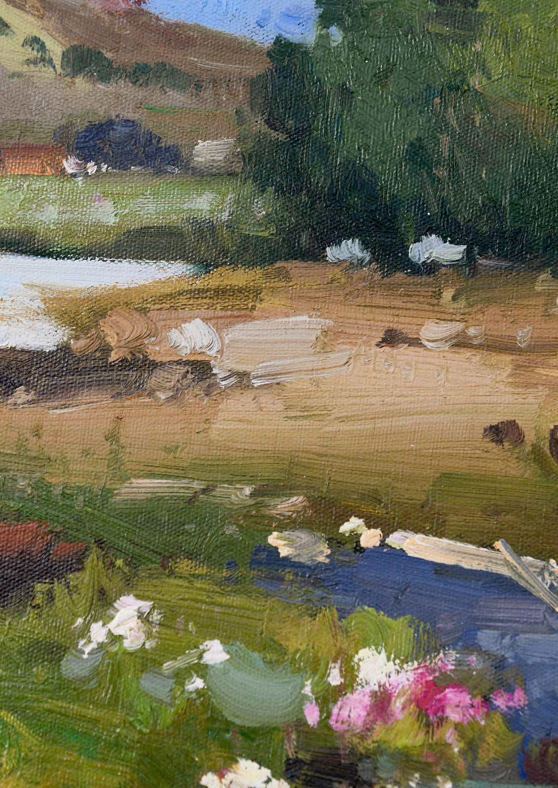 A framed original landscape oil painting of a colorful country meadow.
