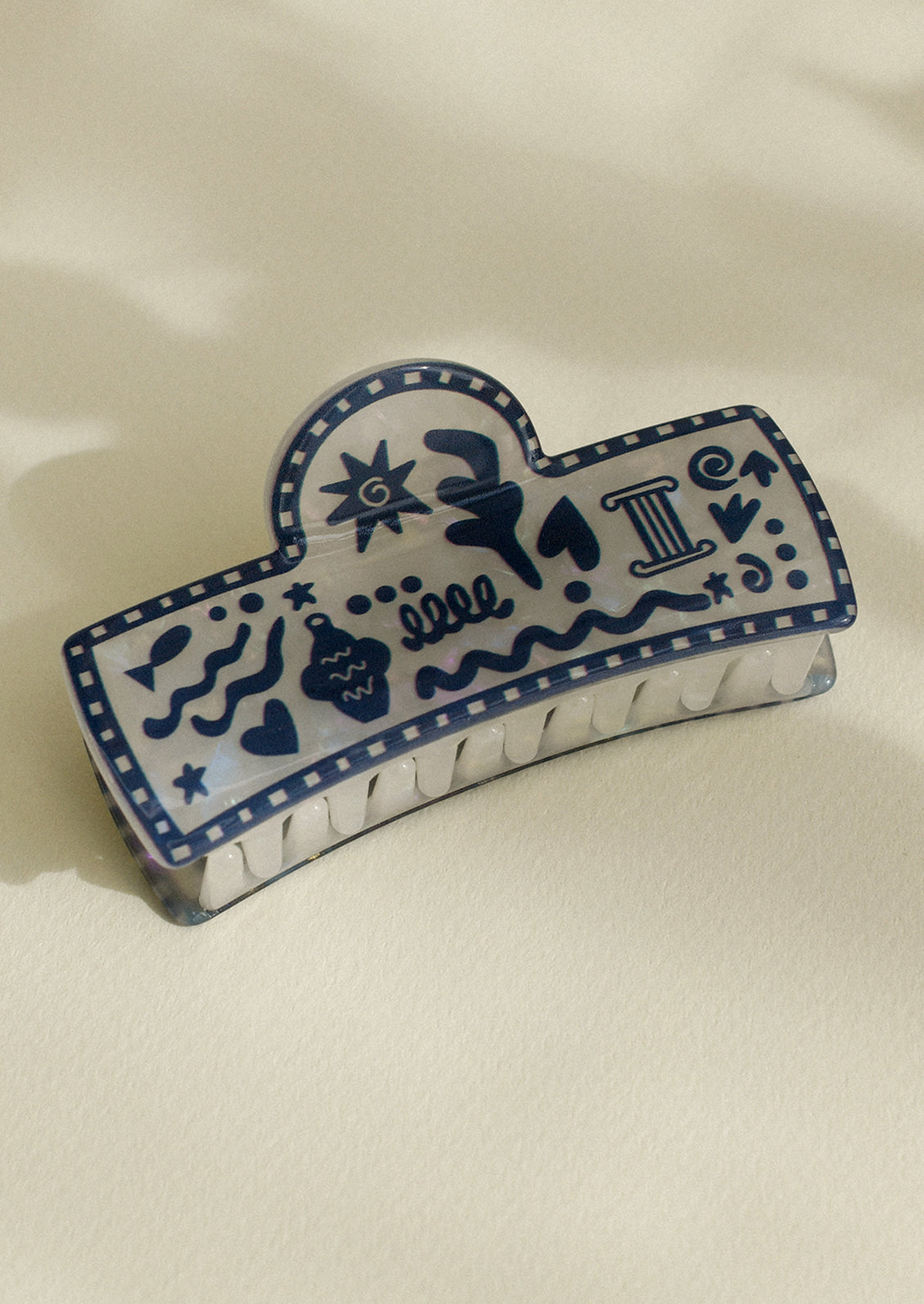 A hair claw with blue Grecian vacation print.