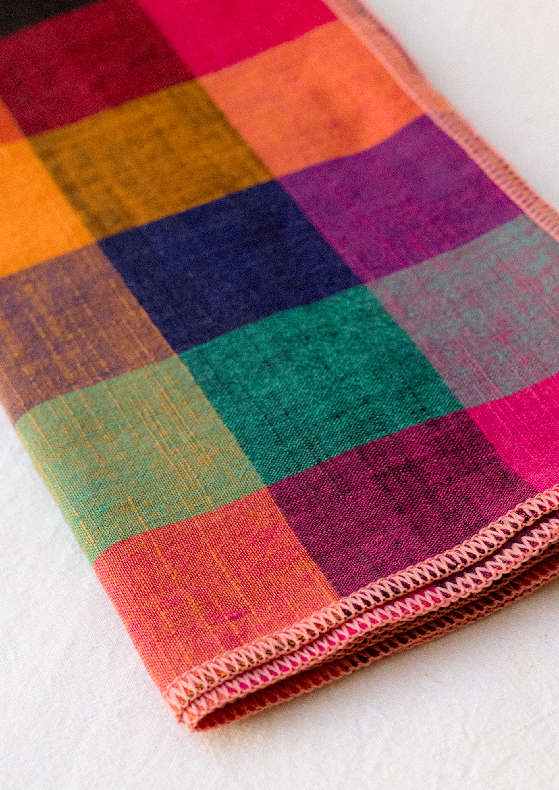 A pair of napkins in colorful gingham check pattern.