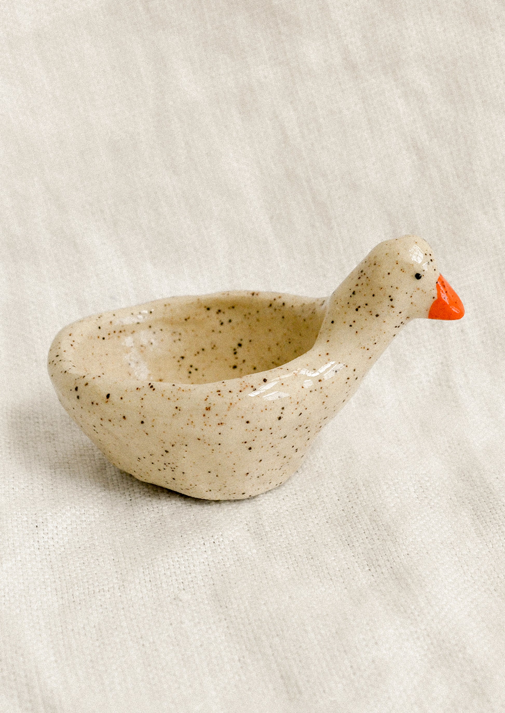 A small bowl dish in the shape of a goose.