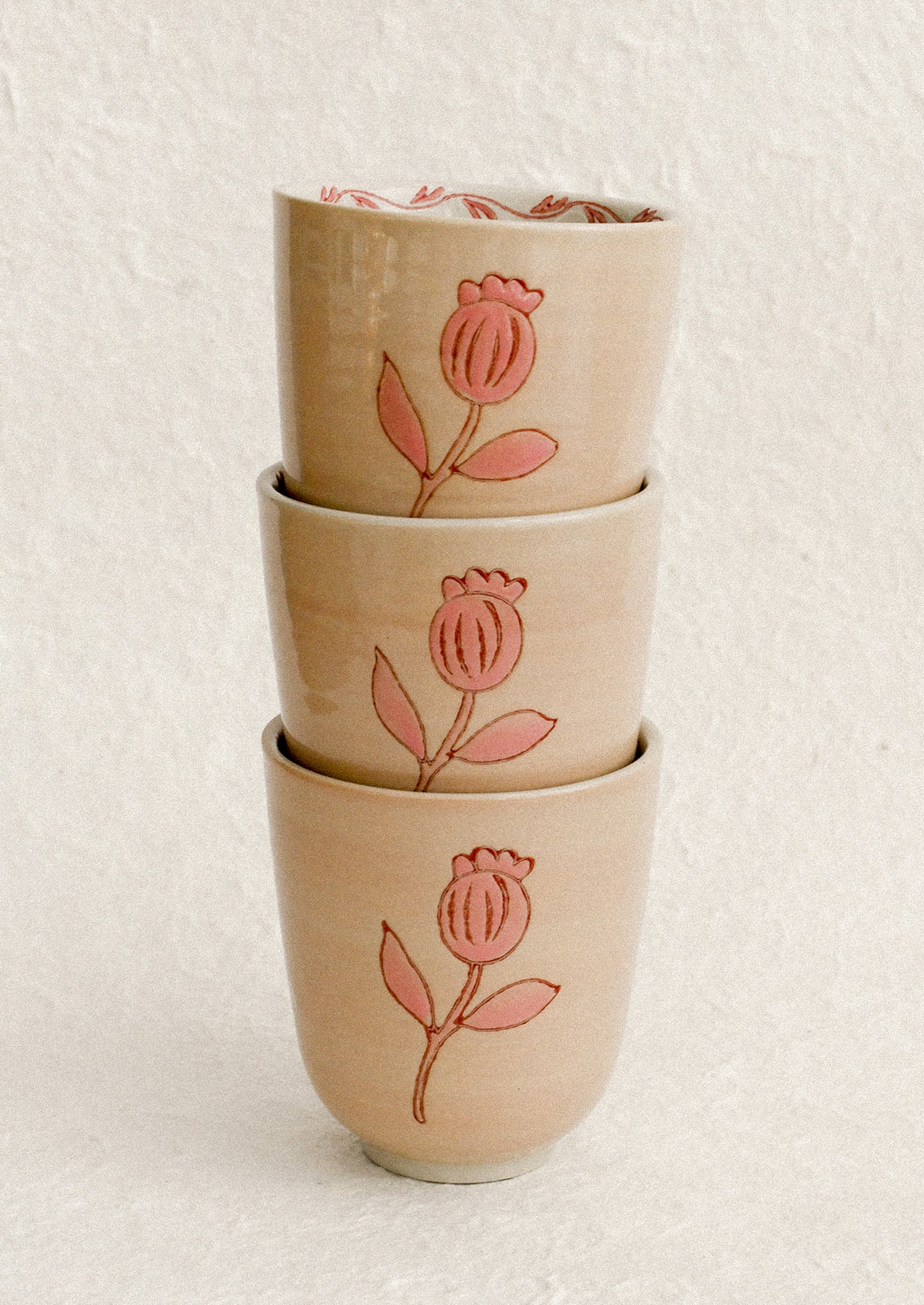 A stack of pink floral print cups.