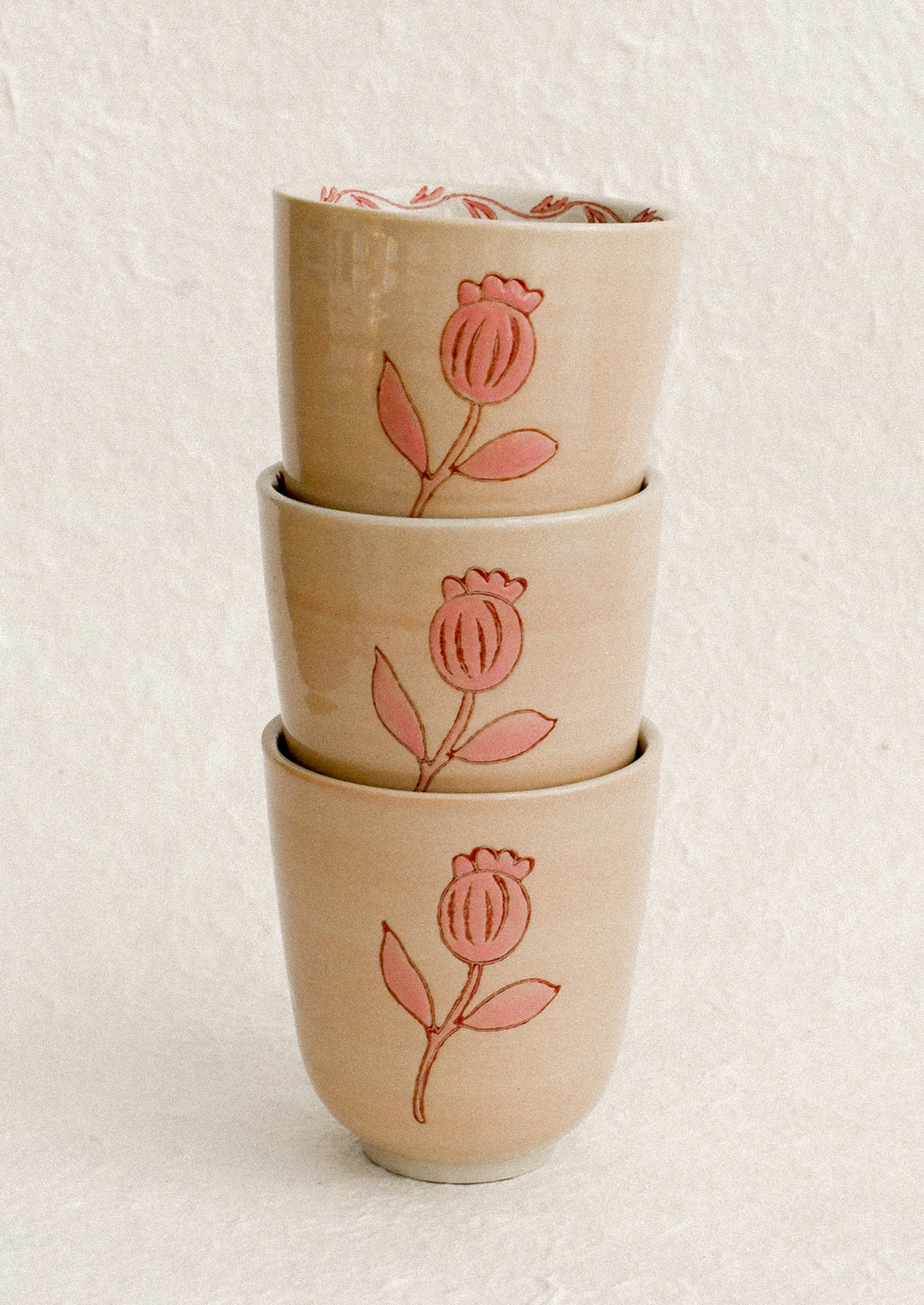 A stack of pink floral print cups.