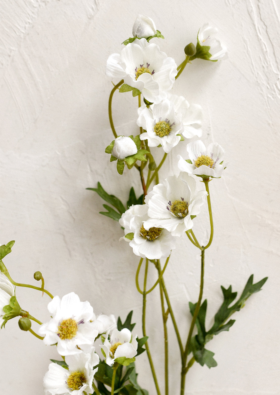 A faux floral spray depicting white wood anemone.