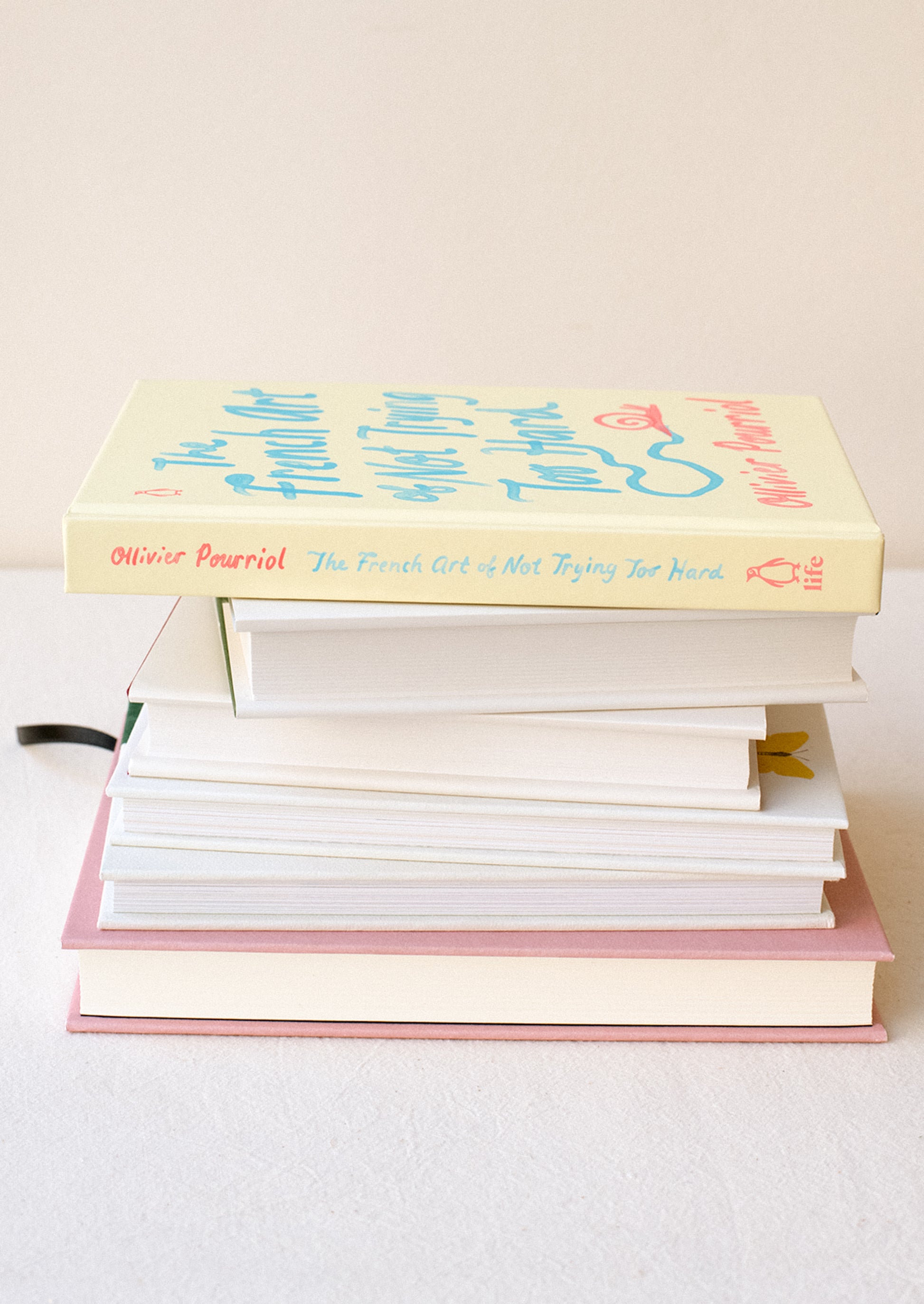 A pale yellow hardcover book titled "The French Art Of Not Trying Too Hard".