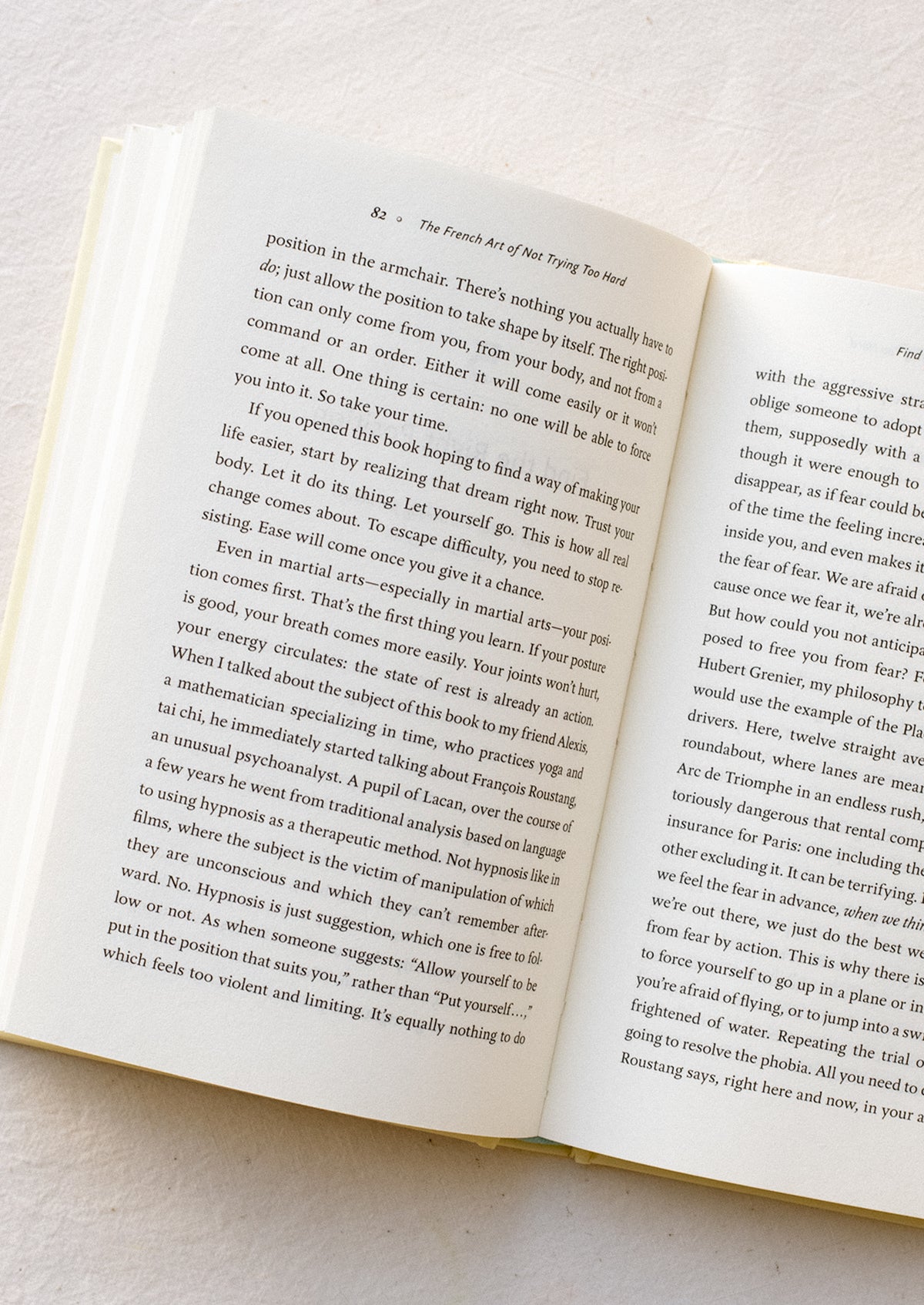 A pale yellow hardcover book titled "The French Art Of Not Trying Too Hard".