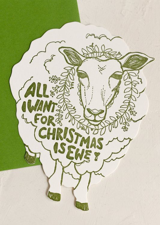 A sheep-shaped die cut card with text reading "All I Want For Christmas Is Ewe!".