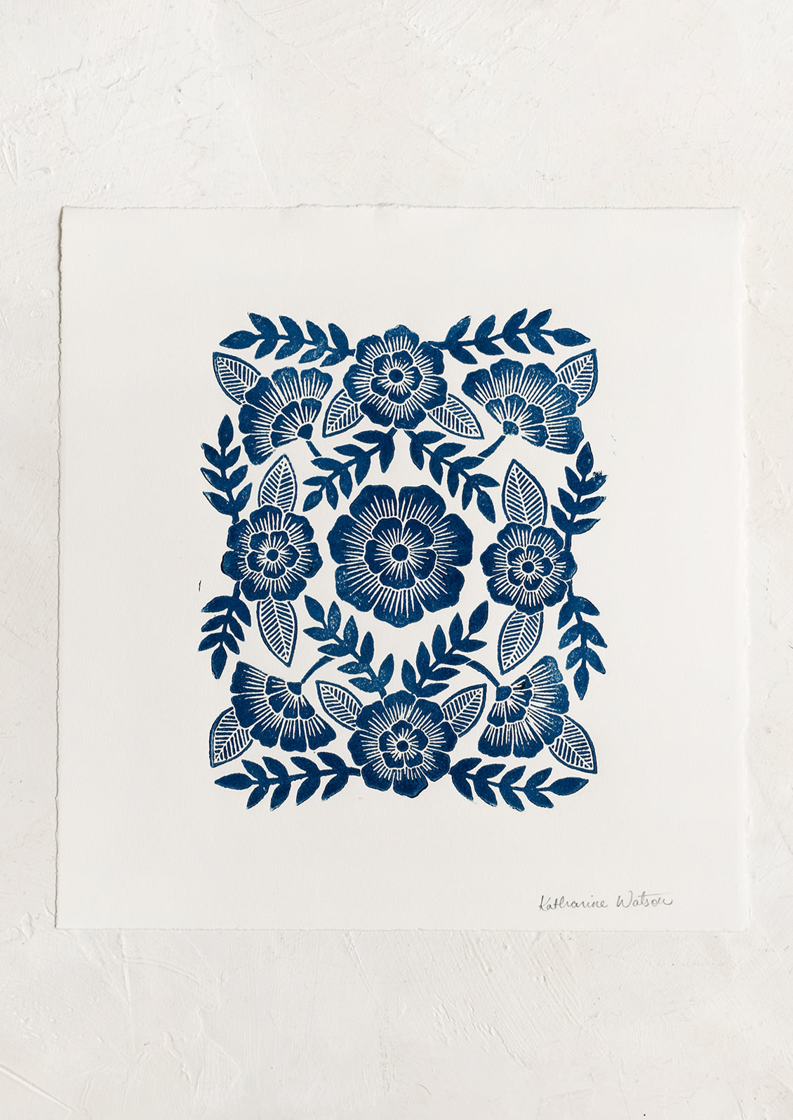 A woodcut floral print block print in indigo ink.