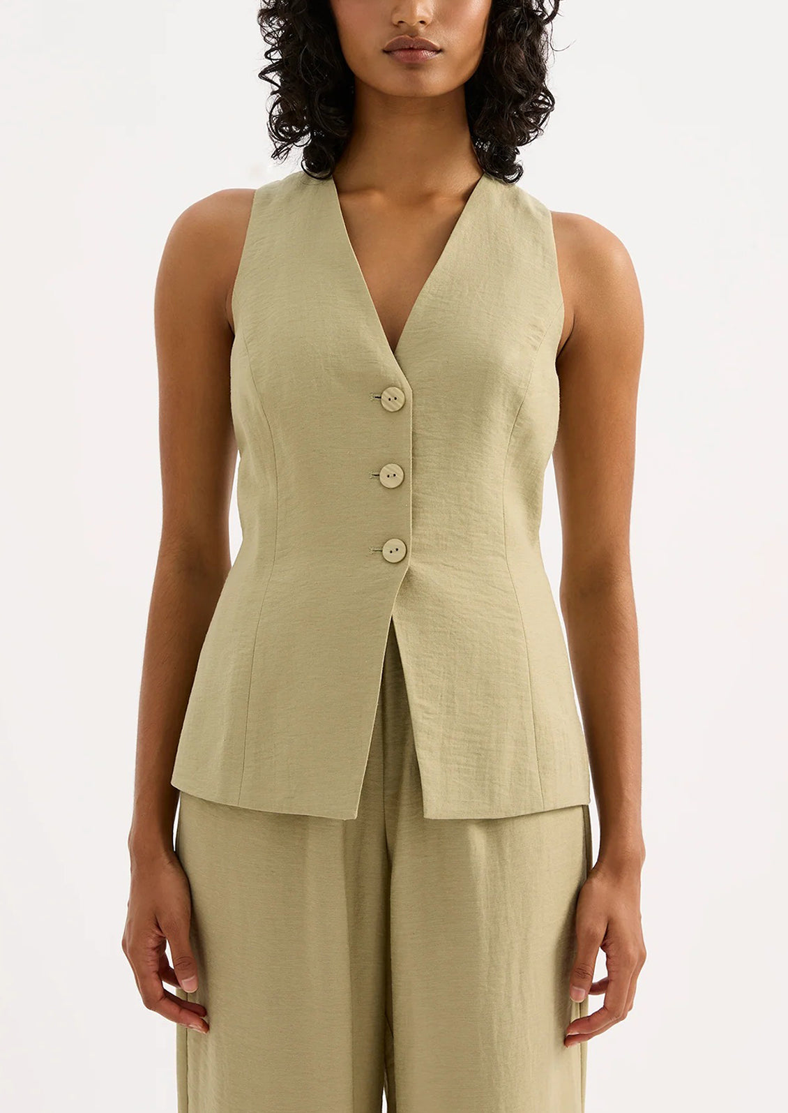 A woman wearing a light green suiting vest.