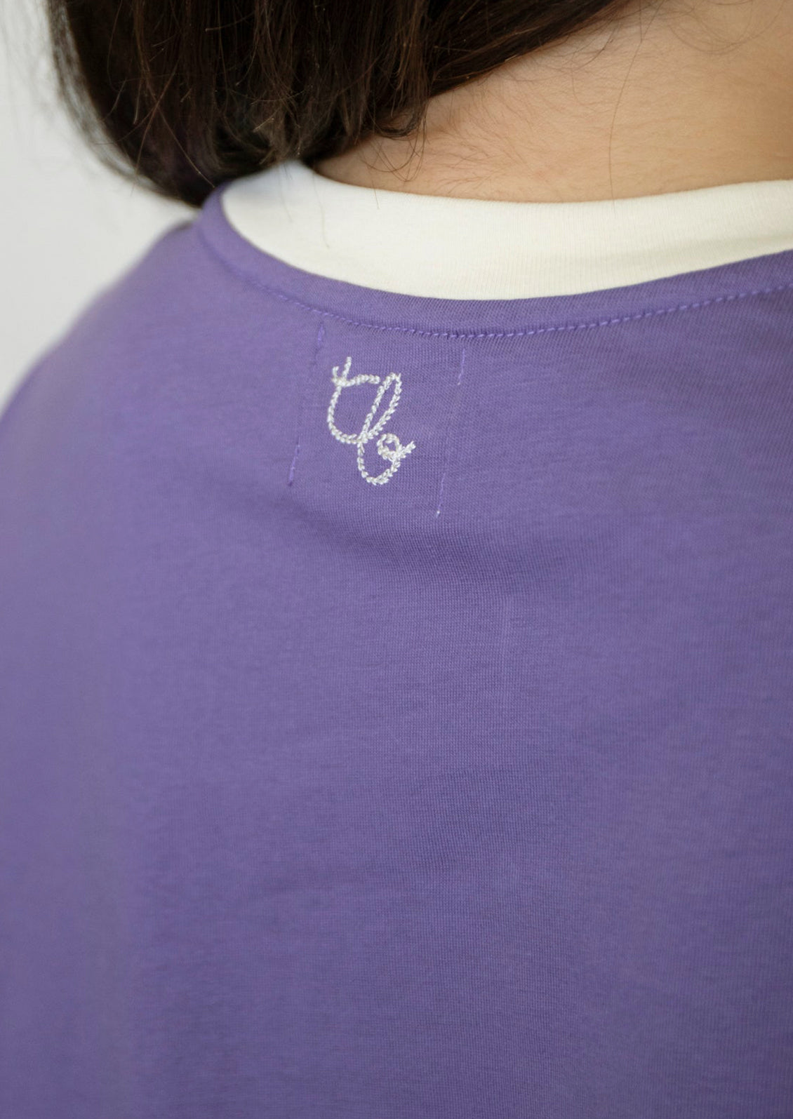 Logo embroidery detail at back of neckline.
