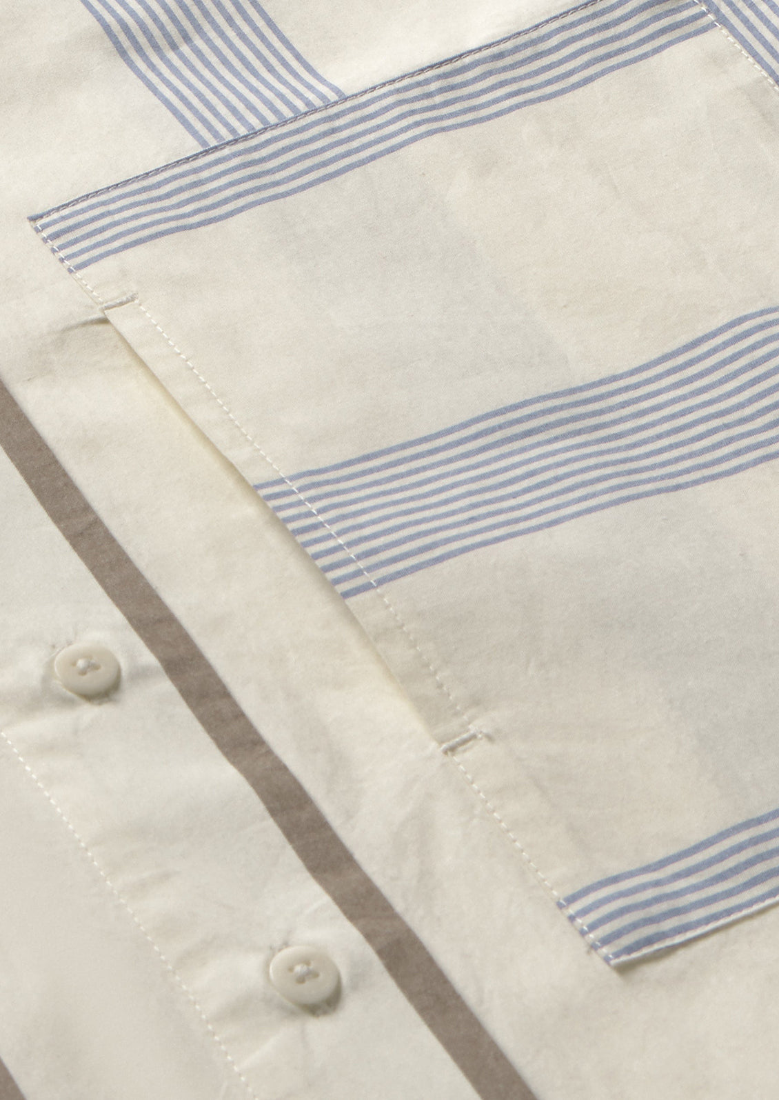 A button down collared shirt with half brown stripes, half blue stripes.