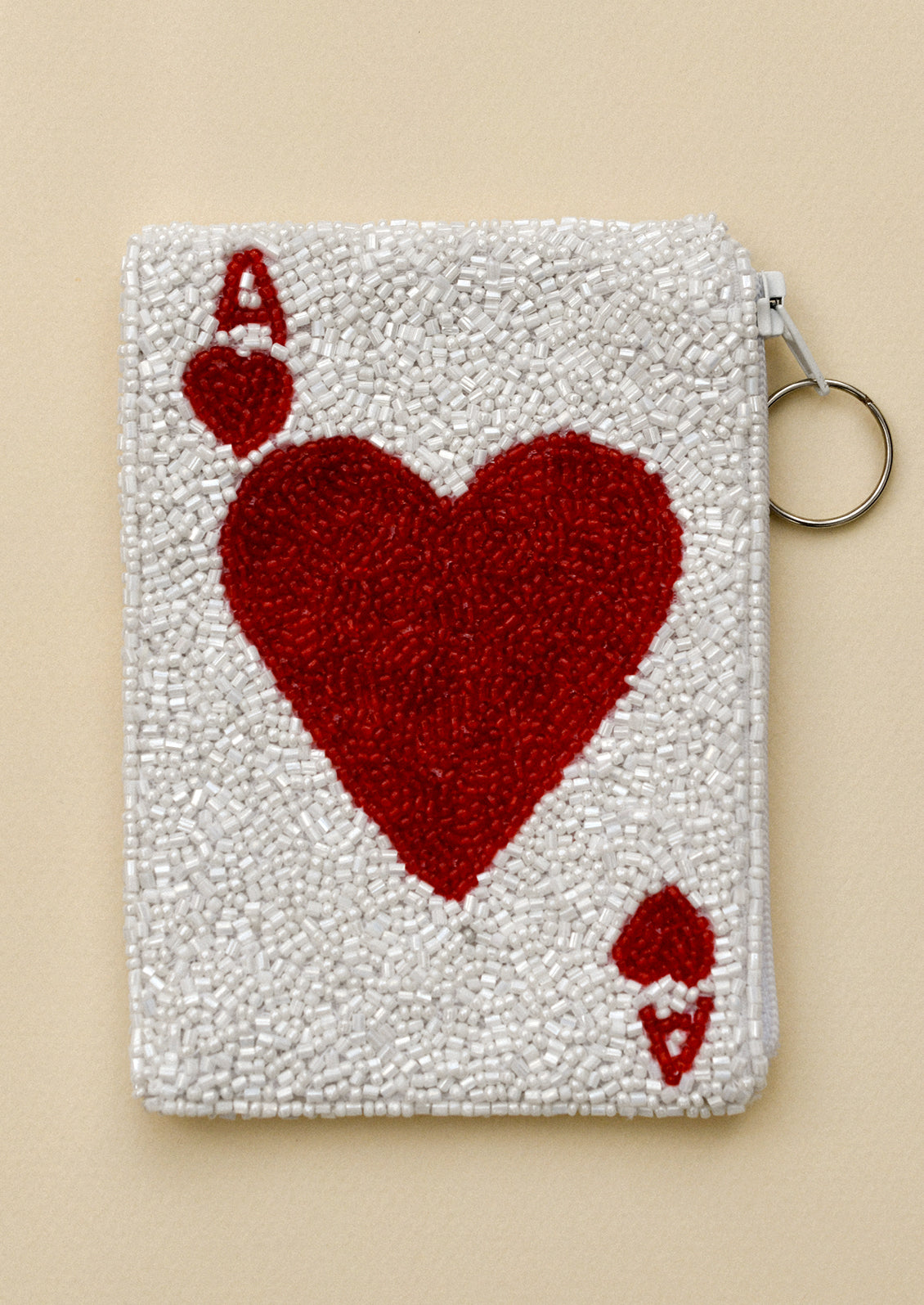 A white beaded coin pouch with ace of hearts design.