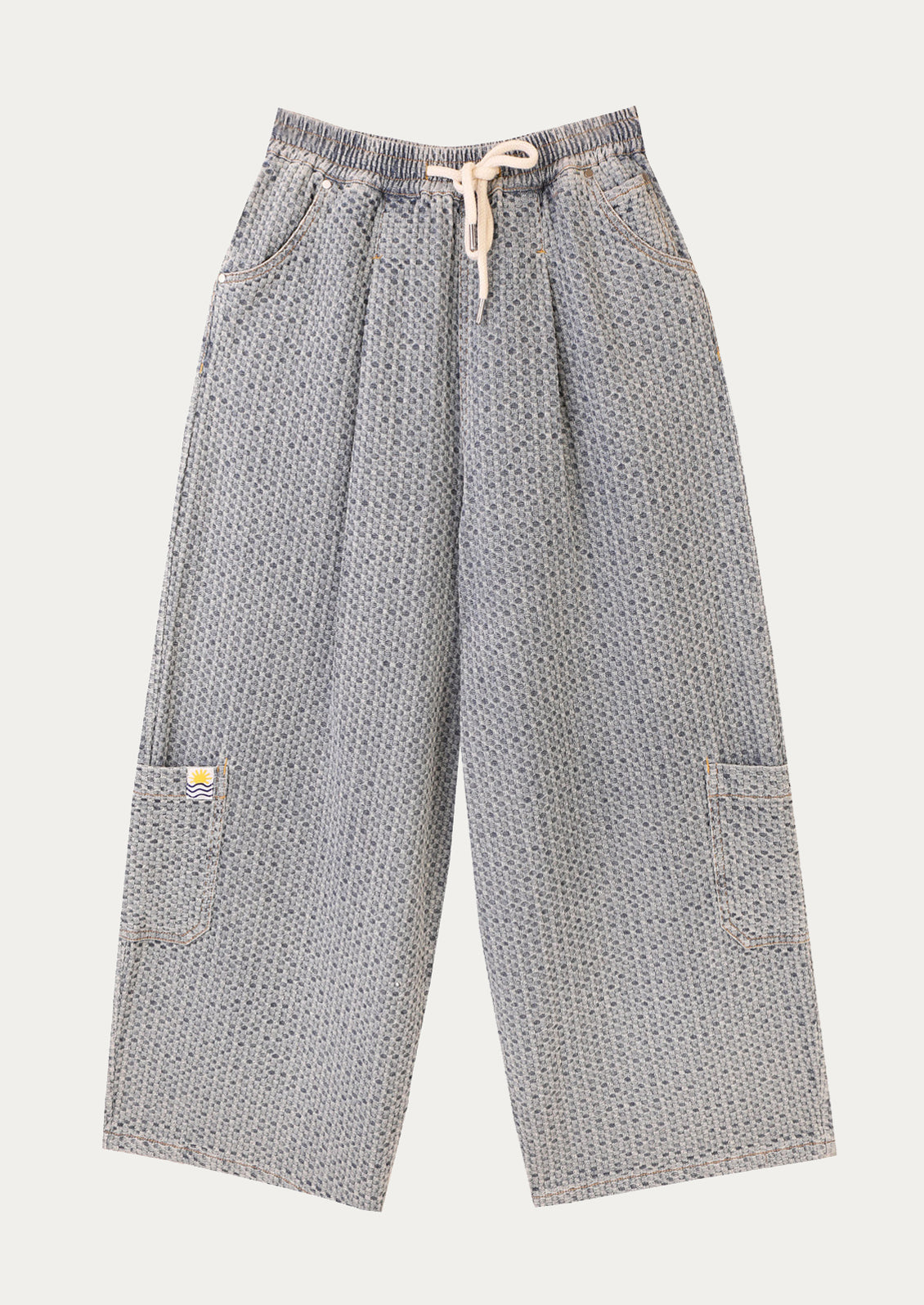 A pair of wide leg, seersucker texture pants in light blue.