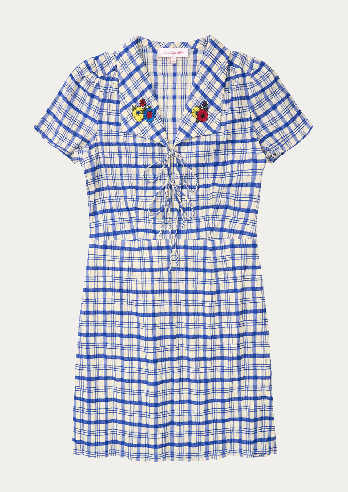 A blue and white plaid mini dress with primary colored floral embroidery at collar.