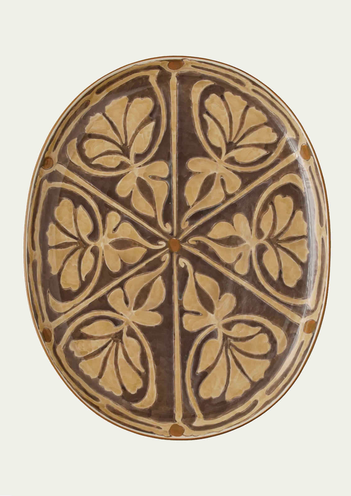 An oval platter in grey with brown Moroccan-inspired design.