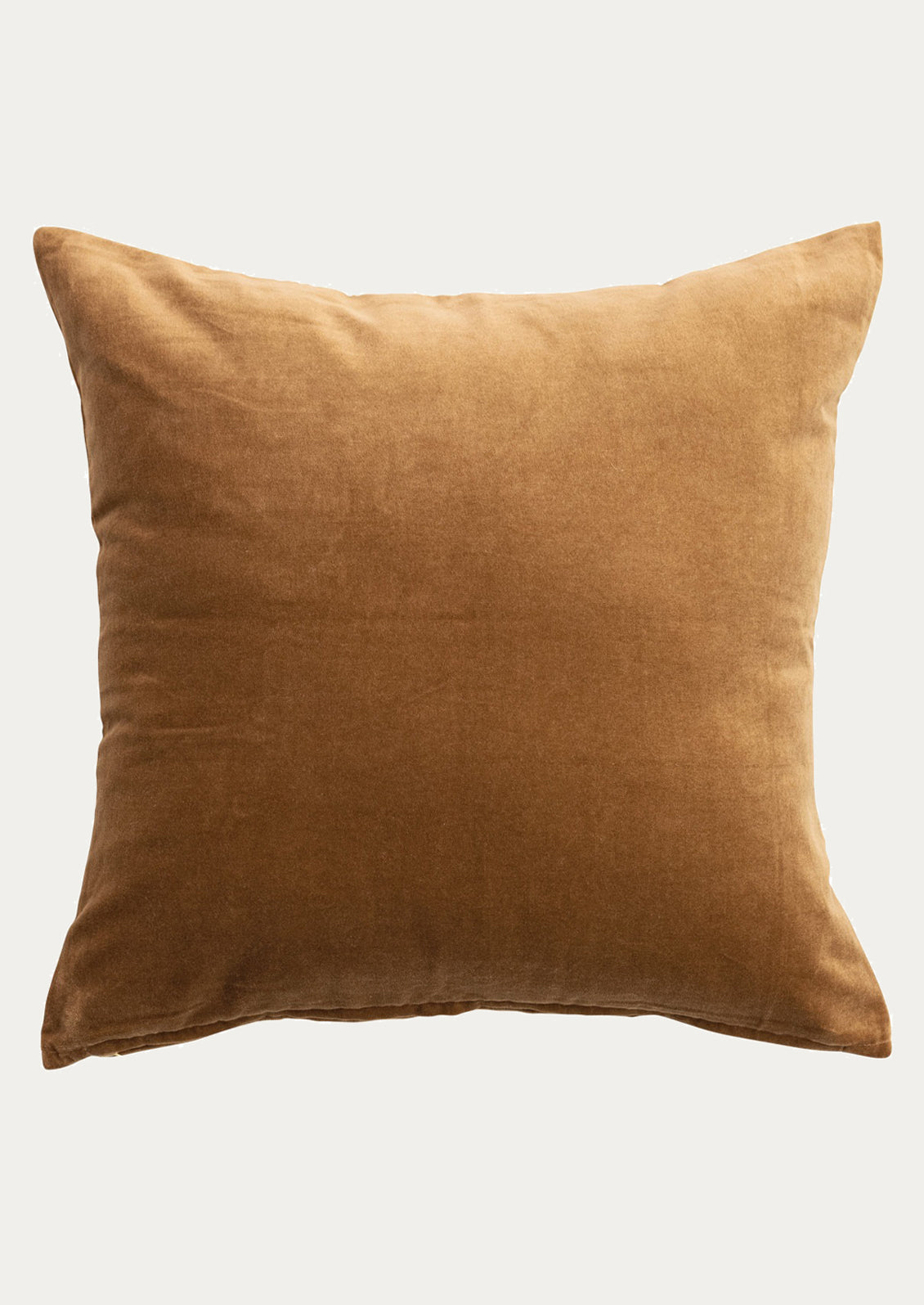 Brown velvet pillow on a light gray background