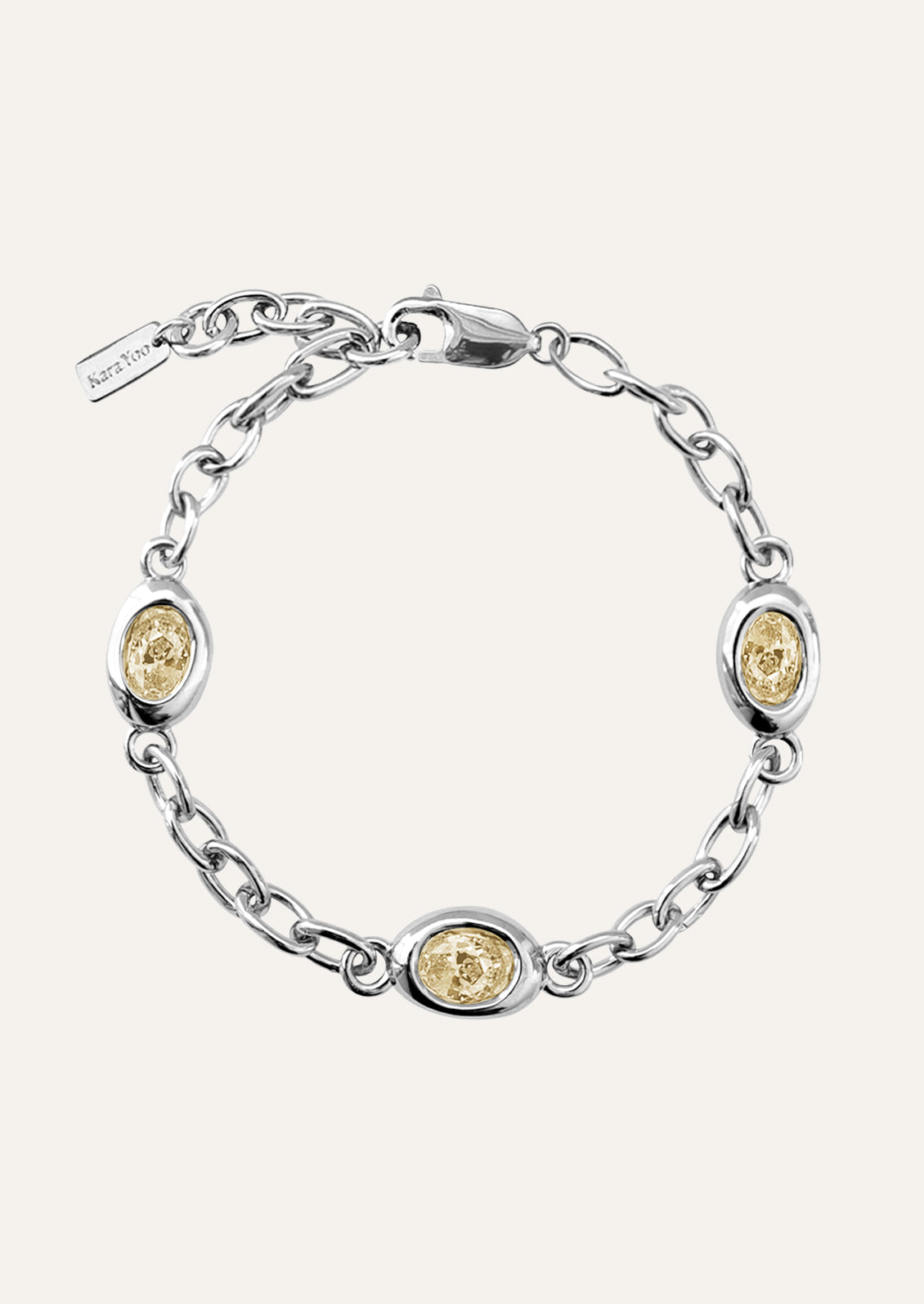 A sterling silver chain bracelet with yellow gems.
