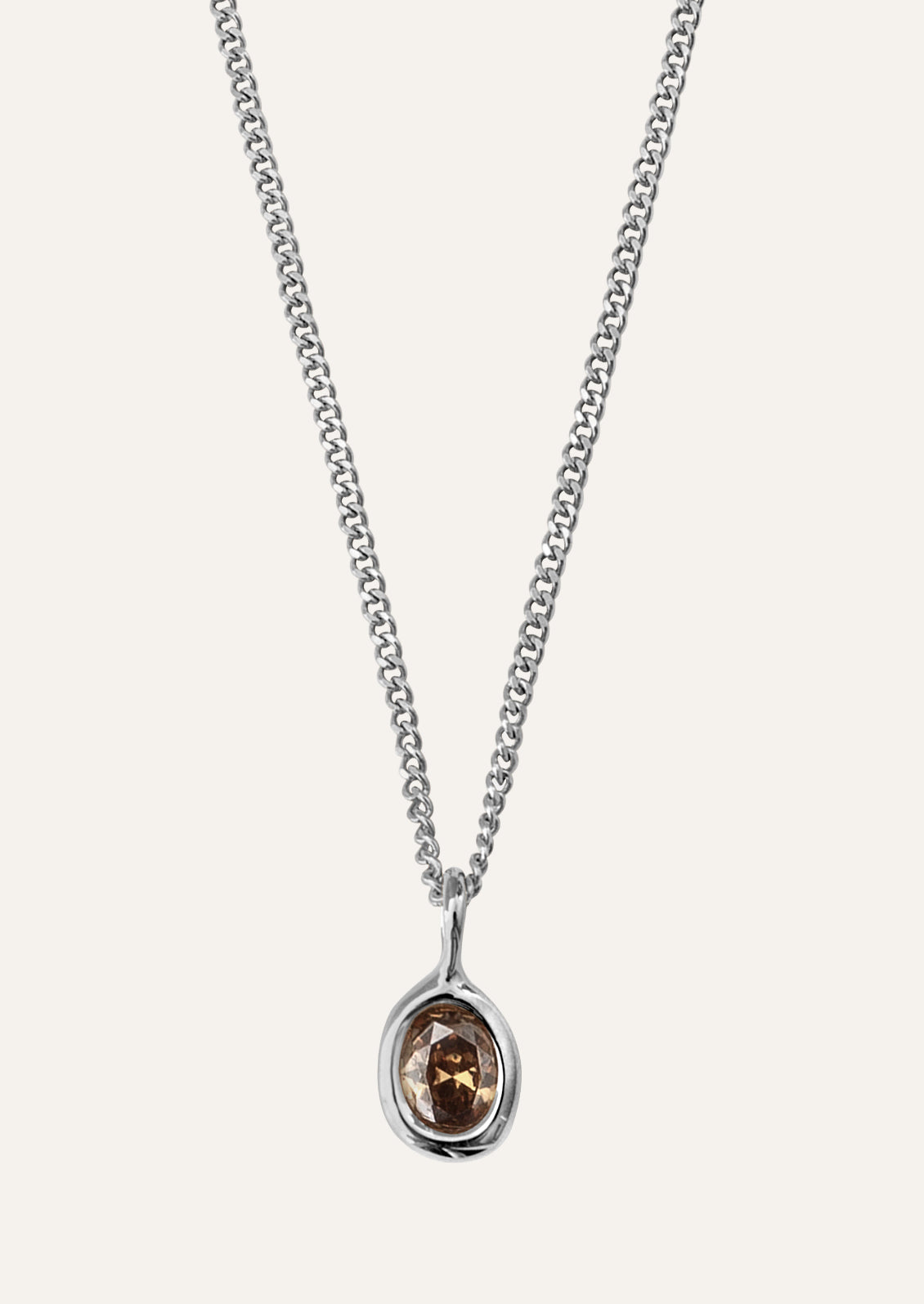 Silver necklace with an oval shaped pendant featuring a brown gemstone.