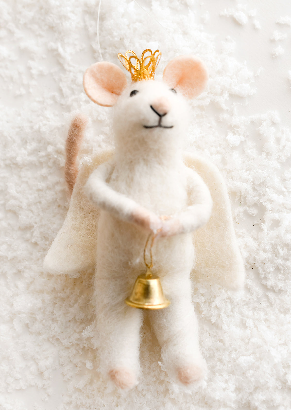 A felted mouse ornament dressed up as an angel.