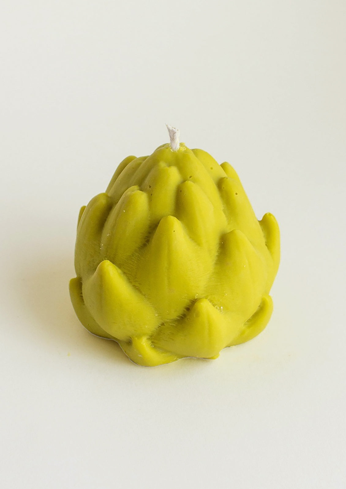 A custom shaped candle in realistic shape of artichoke.